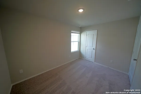 an empty room with windows and closet