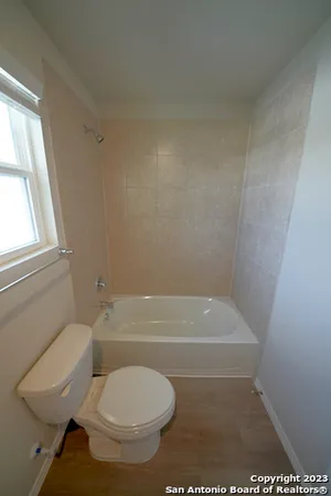 a bathroom with a toilet and a bathtub