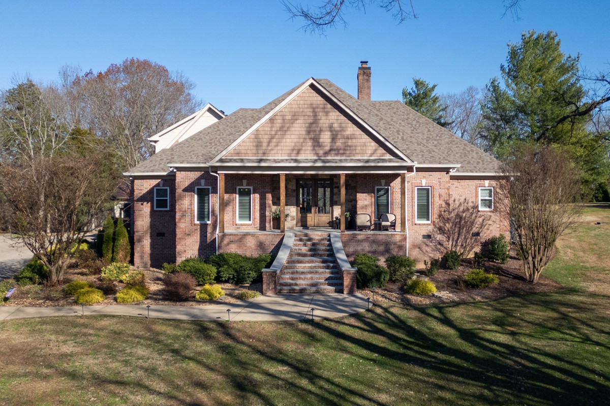 a front view of a house with garden