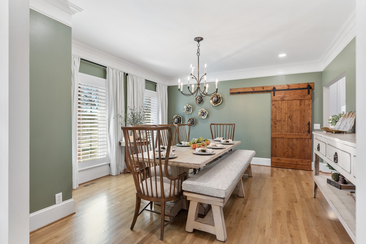 750 Upper Station Camp Creek Road Cottontown, TN 37048 - Photo 11 of 71 a view of a dining room with furniture a chandelier and wooden floor