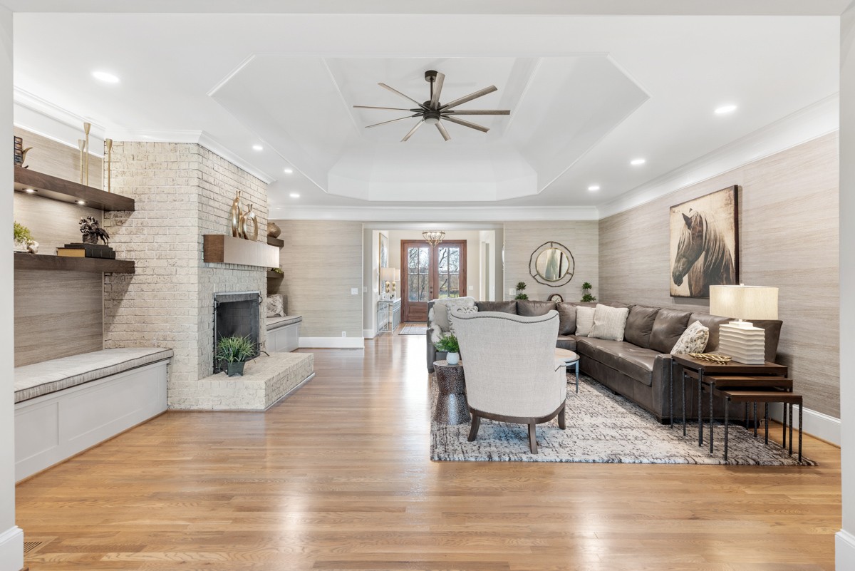 750 Upper Station Camp Creek Road Cottontown, TN 37048 - Photo 16 of 71 a living room with furniture a fireplace and a chandelier