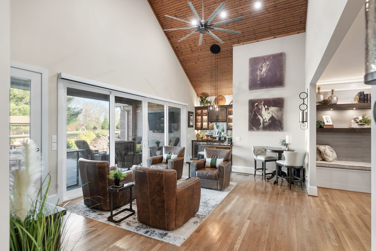 750 Upper Station Camp Creek Road Cottontown, TN 37048 - Photo 19 of 71 a living room with furniture a wooden floor and a large window