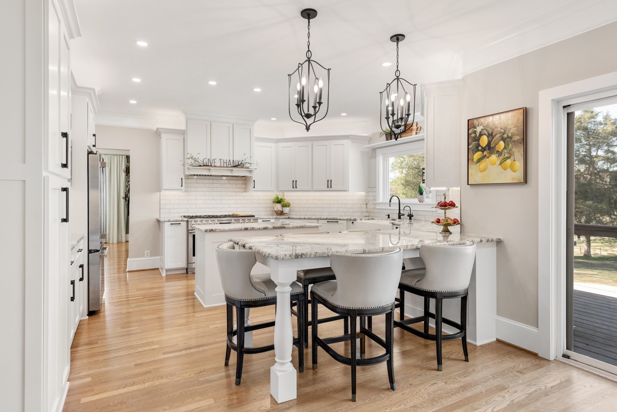 750 Upper Station Camp Creek Road Cottontown, TN 37048 - Photo 22 of 71 a dining room filled chandelier and wooden floor
