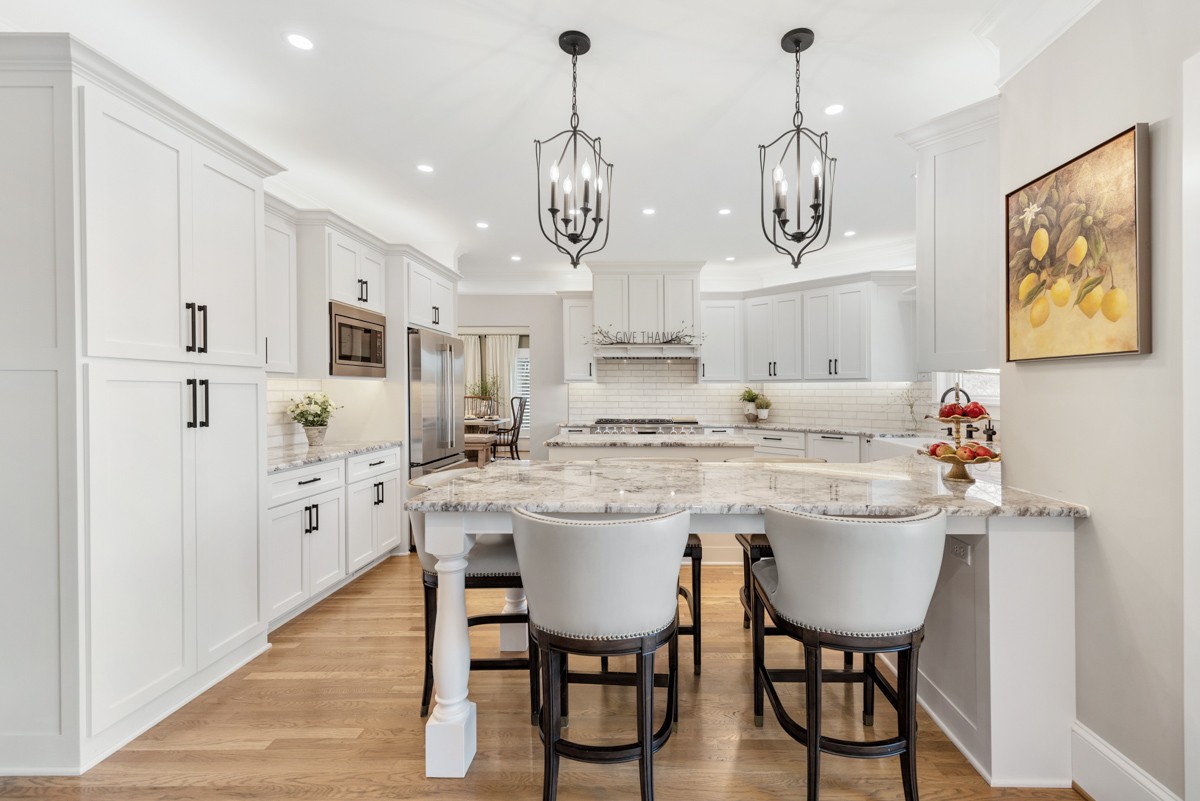 750 Upper Station Camp Creek Road Cottontown, TN 37048 - Photo 23 of 71 a kitchen with stainless steel appliances kitchen island granite countertop a dining table chairs and white cabinets