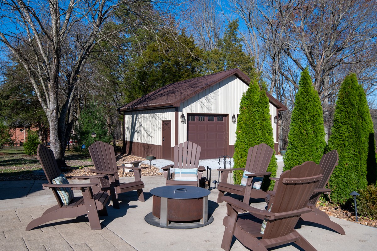 750 Upper Station Camp Creek Road Cottontown, TN 37048 - Photo 59 of 71 a view of a patio with couches table and chairs and wooden fence