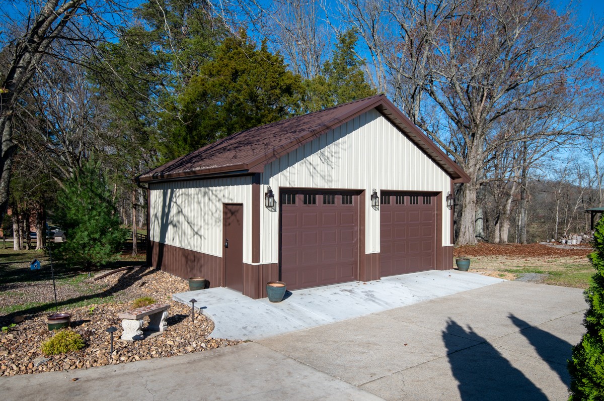 750 Upper Station Camp Creek Road Cottontown, TN 37048 - Photo 60 of 71 a front view of a house with a yard and garage