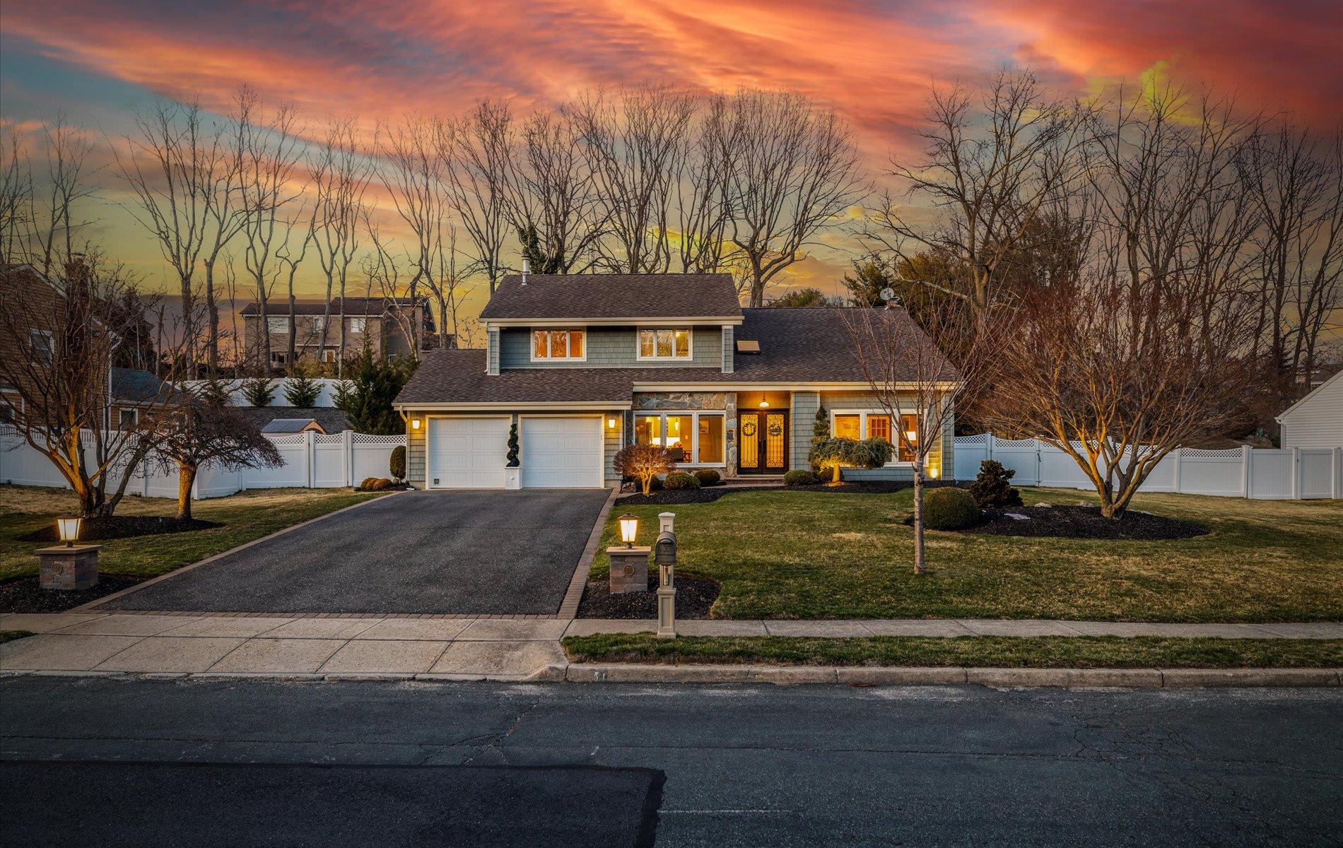 54 Timber Ridge Drive Commack, NY 11725 - Photo 1 of 1 Traditional home with an attached garage, aphalt driveway, fence, and a front lawn
