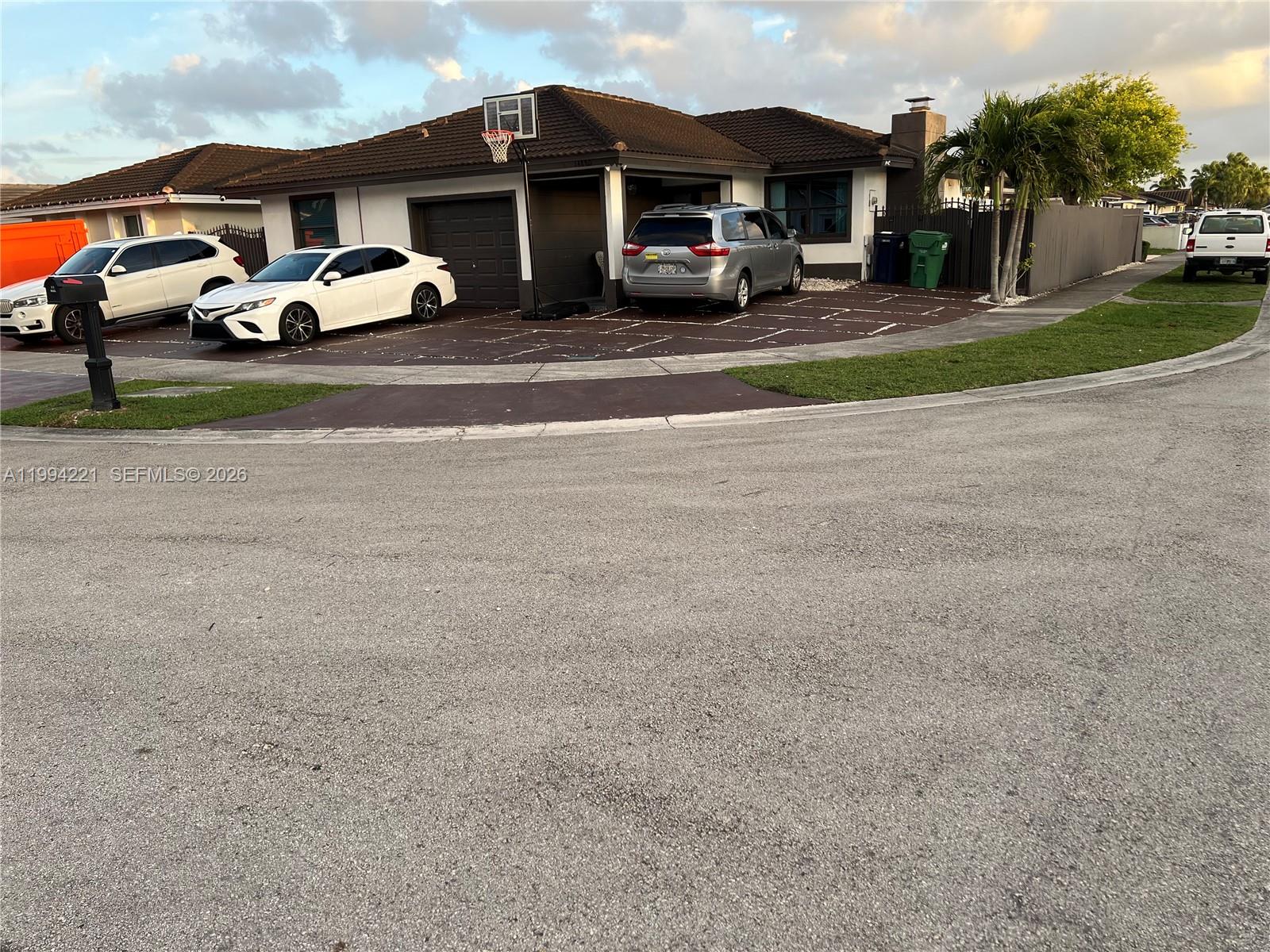 a car parked in front of white house