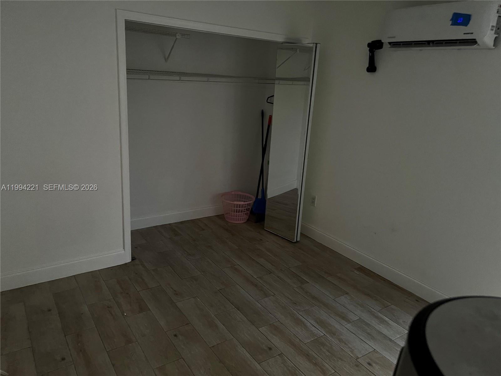 14880 Southwest 56th Terrace, Unit 3 Miami, FL 33193 - Photo 5 of 8 a view of an empty room with wooden floor