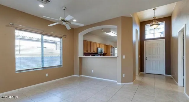 a view of an empty room with window and cabinet