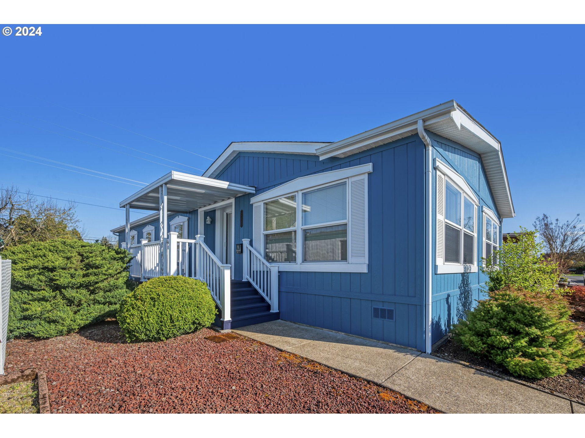 2150 Laura Street, Unit 217 Springfield, OR 97477 - Photo 1 of 32 a front view of a house with a garden