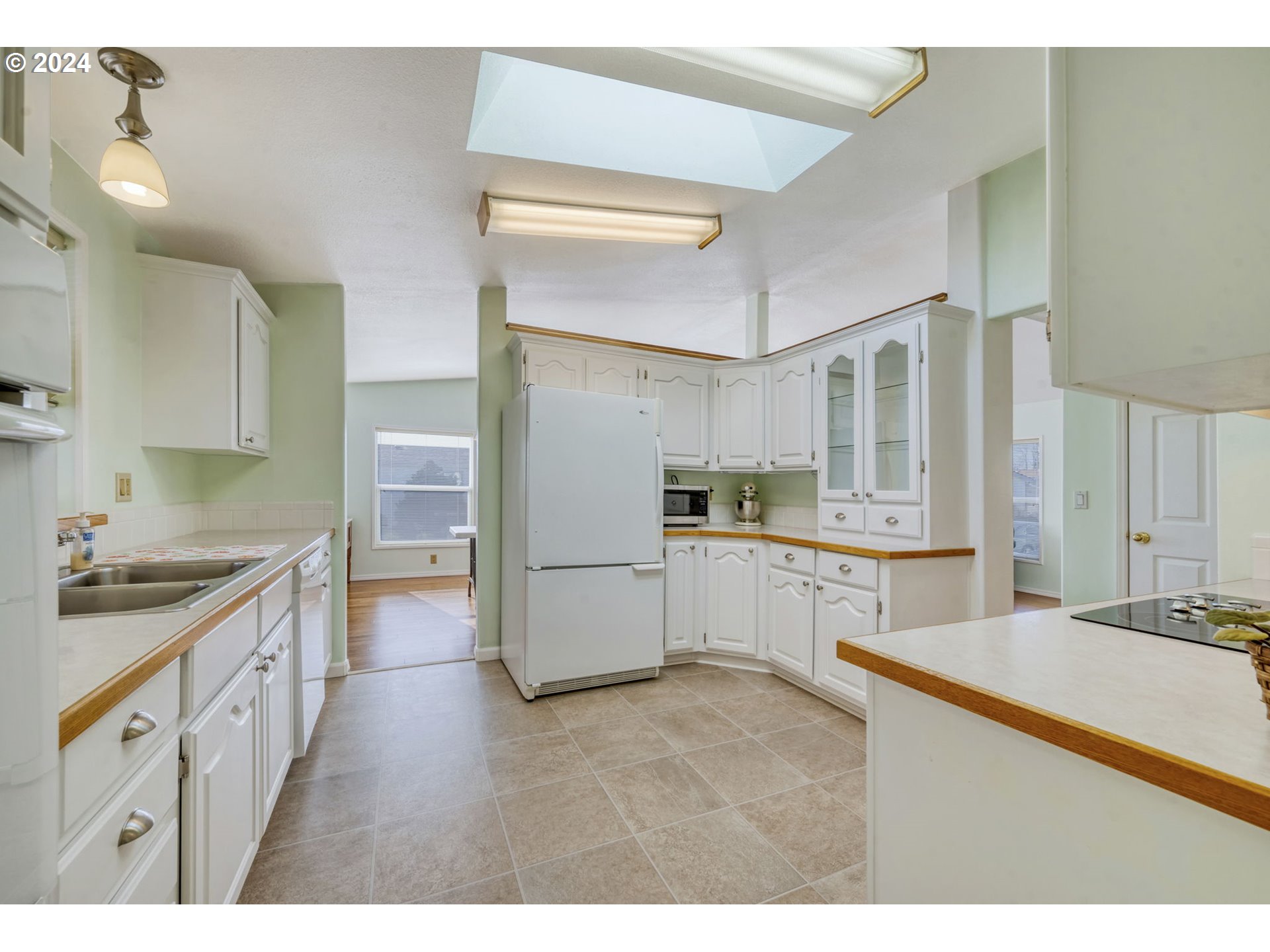 2150 Laura Street, Unit 217 Springfield, OR 97477 - Photo 11 of 32 a kitchen with stainless steel appliances kitchen island granite countertop a refrigerator and a stove top oven