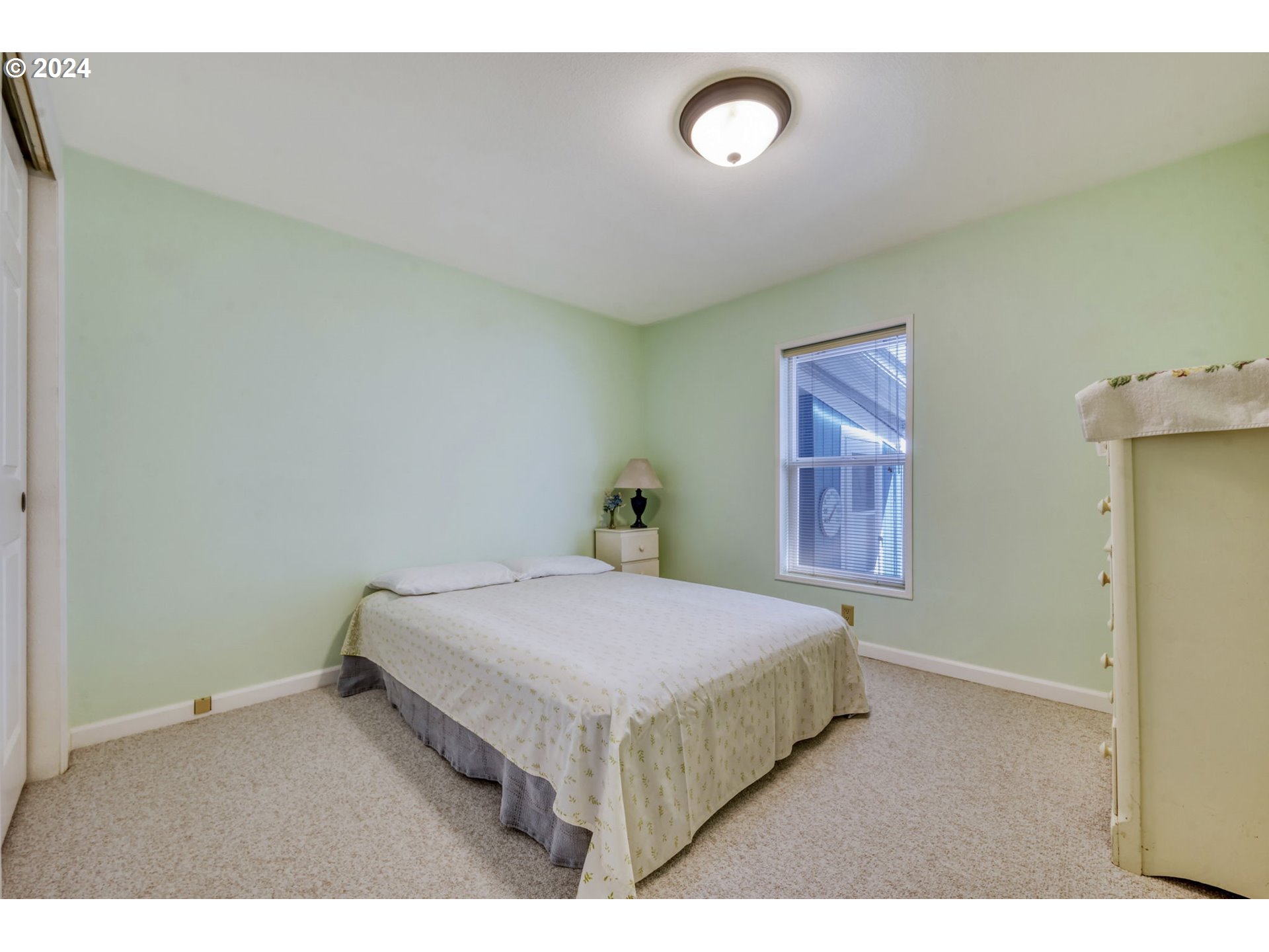 2150 Laura Street, Unit 217 Springfield, OR 97477 - Photo 23 of 32 a bedroom with a bed and a lamp