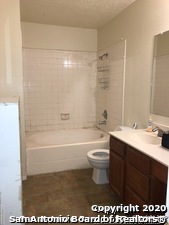 8401 Forest Ridge Drive San Antonio, TX 78239 - Photo 3 of 12 a bathroom with a sink a toilet and bathtub