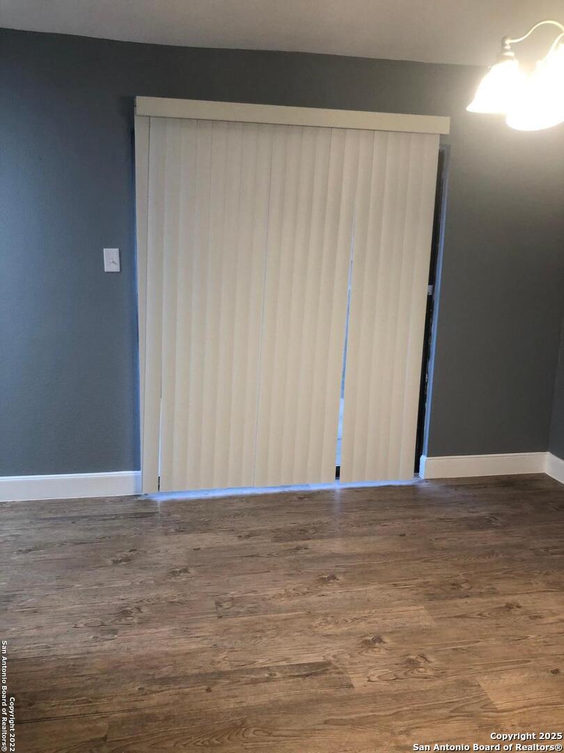 8401 Forest Ridge Drive San Antonio, TX 78239 - Photo 5 of 12 a view of an empty room with wooden floor and a window