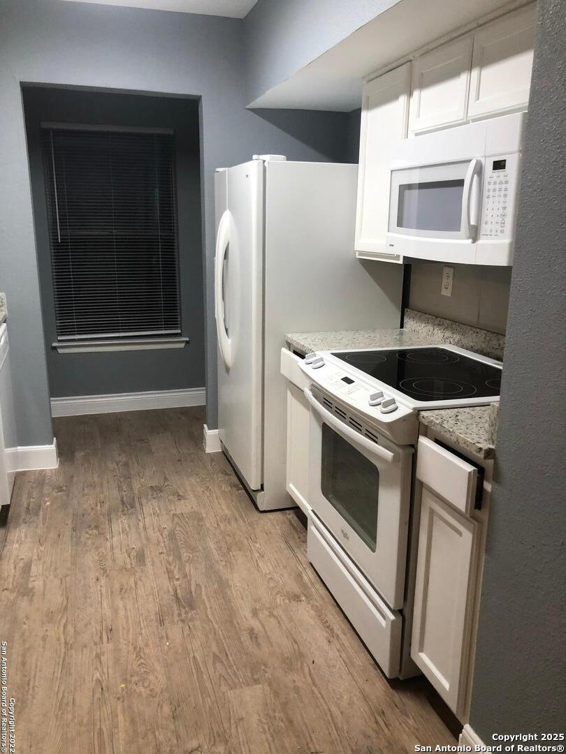 8401 Forest Ridge Drive San Antonio, TX 78239 - Photo 6 of 12 a kitchen with a stove and a microwave