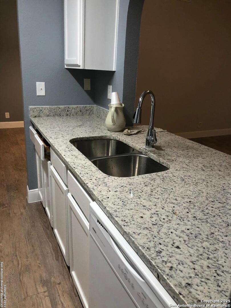 8401 Forest Ridge Drive San Antonio, TX 78239 - Photo 8 of 12 a kitchen with a sink and a stove with wooden floor
