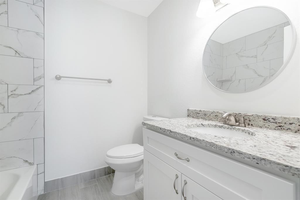 7500 Northwest 75th Street Fort Lauderdale, FL 33321 - Photo 3 of 16 a bathroom with a granite countertop sink a toilet and a mirror