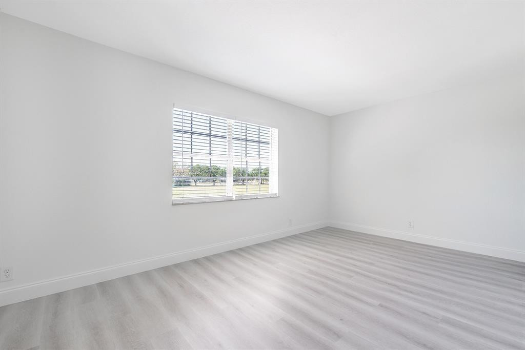 7500 Northwest 75th Street Fort Lauderdale, FL 33321 - Photo 6 of 16 an empty room with wooden floor and windows