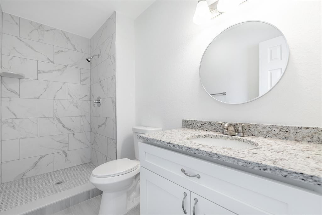 7500 Northwest 75th Street Fort Lauderdale, FL 33321 - Photo 7 of 16 a bathroom with a granite countertop sink mirror vanity and toilet