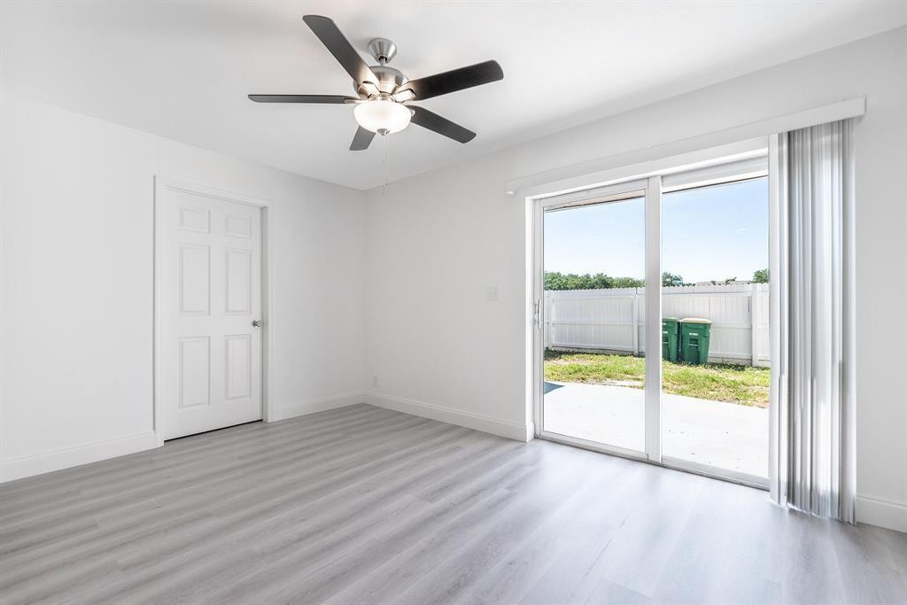 7500 Northwest 75th Street Fort Lauderdale, FL 33321 - Photo 8 of 16 an empty room with wooden floor and windows