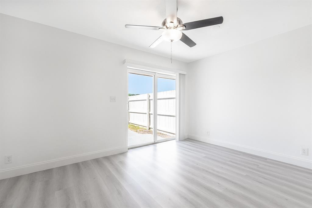 7500 Northwest 75th Street Fort Lauderdale, FL 33321 - Photo 9 of 16 an empty room with wooden floor and windows