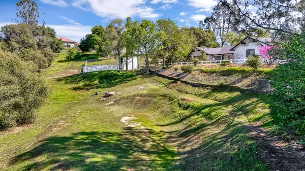 a view of a roof deck with wooden fence and a bench