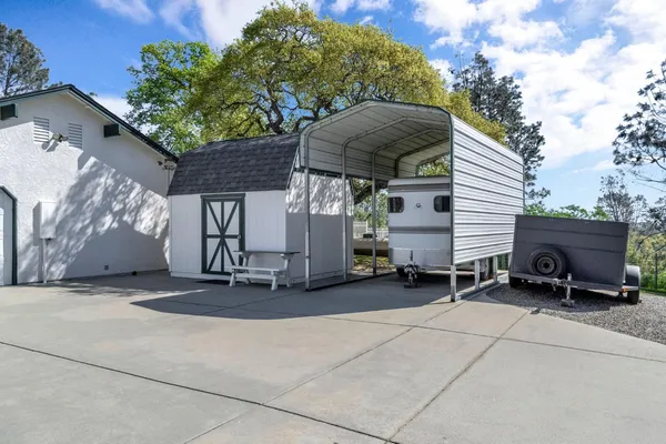 a view of a dining room with furniture and a chandelier