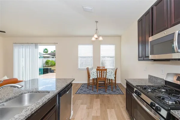 a kitchen with stainless steel appliances granite countertop a sink stove and granite counter top