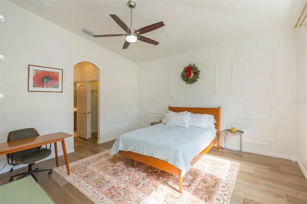 a bedroom with a bed and a workspace