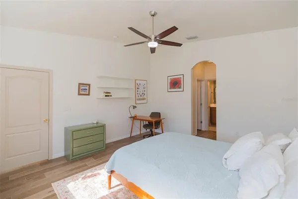 a bedroom with a bed and a chandelier