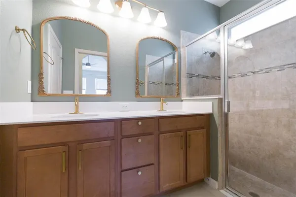 a bathroom with a double vanity sink and a mirror