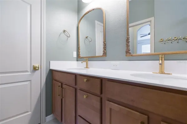 a bathroom with a double vanity sink and a mirror