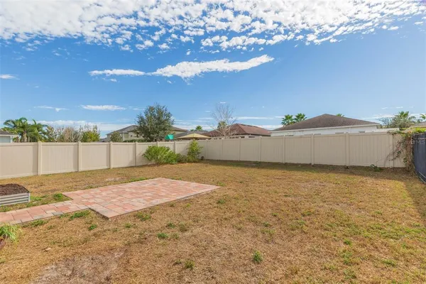 a view of a backyard with a tub and lake view