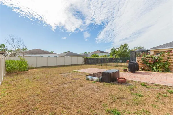 a front view of a house with a yard and ocean view