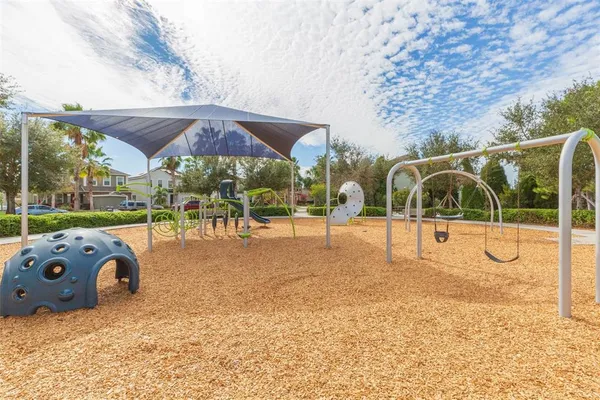 a view of swimming pool with table and chairs