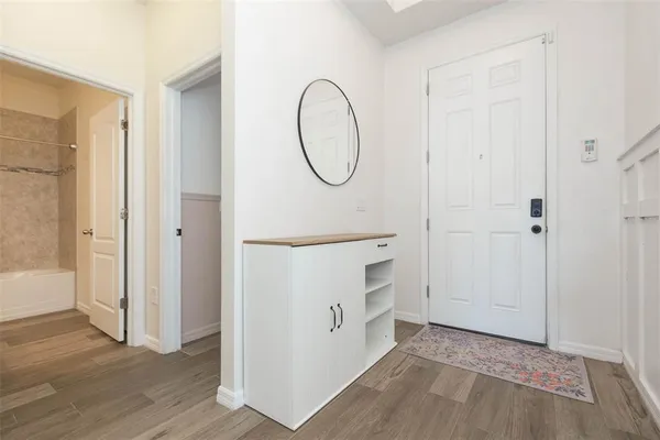 a room with white cabinets and a mirror