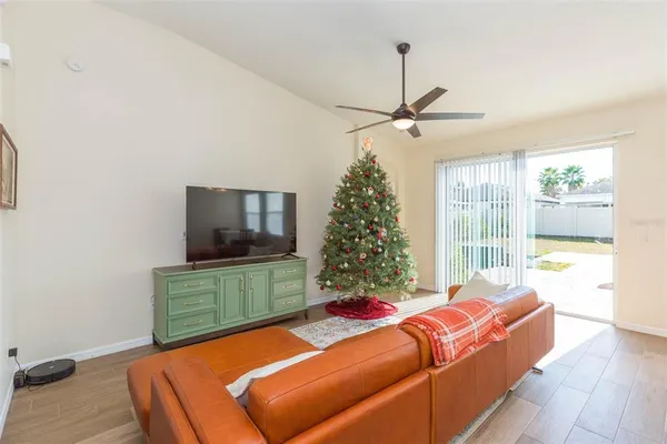 a living room with a bed furniture and a flat screen tv