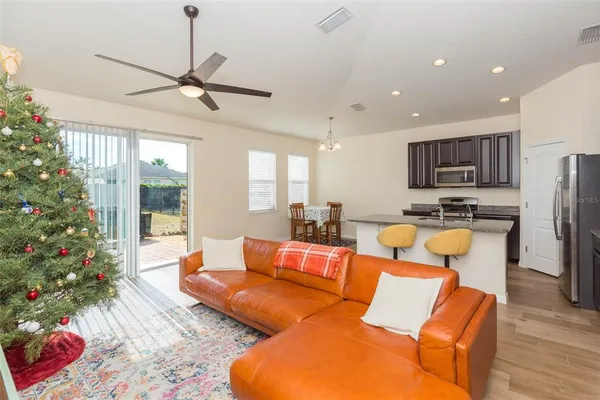 a living room with patio furniture and a potted plant