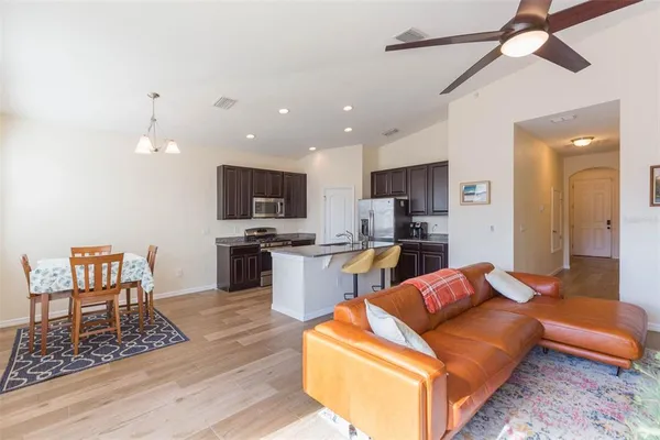 a living room with furniture and kitchen view