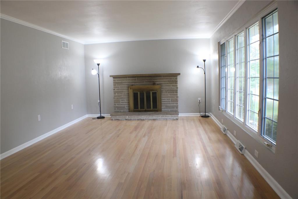 312 Cherokee Drive Butler, PA 16001 - Photo 22 of 40 an empty room with wooden floor fireplace and windows