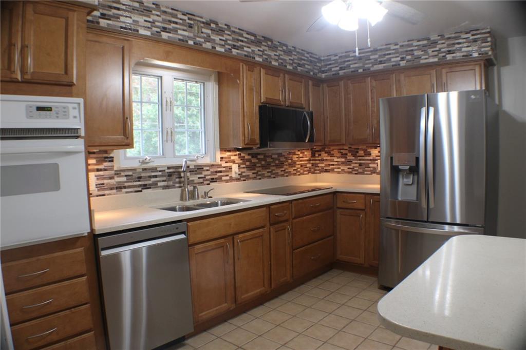 312 Cherokee Drive Butler, PA 16001 - Photo 10 of 40 a kitchen with stainless steel appliances granite countertop a refrigerator and a sink