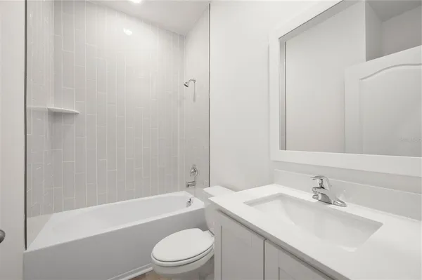 a bathroom with a sink a toilet and bathtub