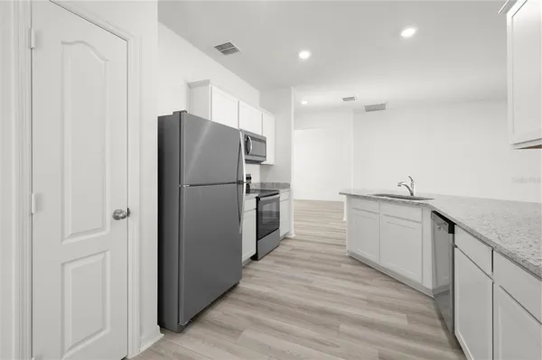a kitchen with a refrigerator and a sink