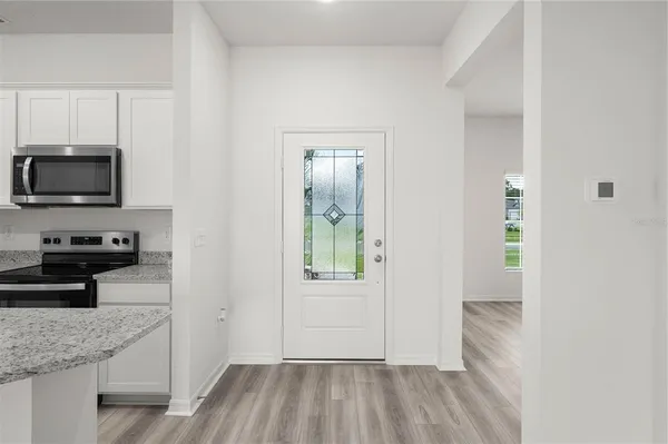 a kitchen with a refrigerator and a stove top oven