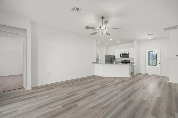 a view of kitchen with cabinets and wooden floor