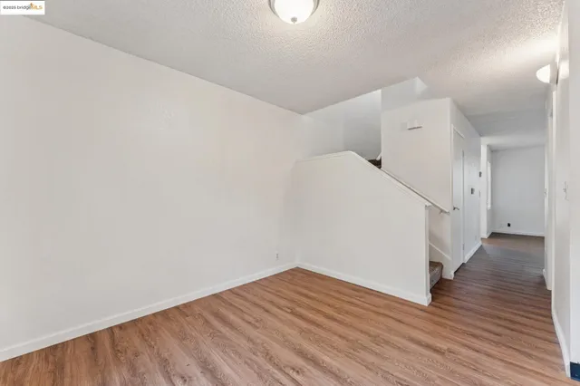 a view of a room with wooden floor
