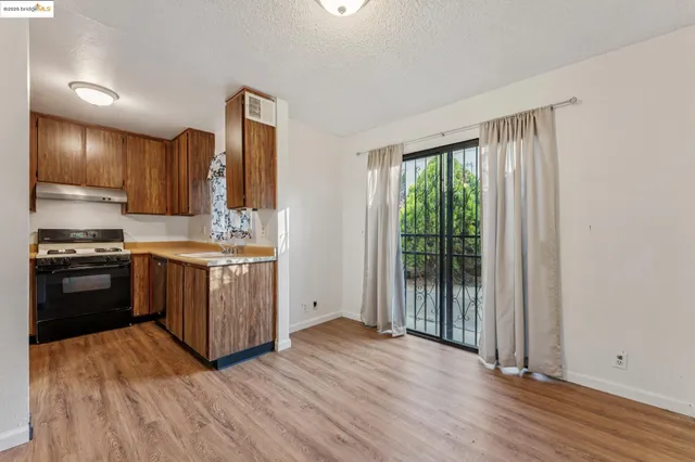 a kitchen with wooden floors and appliances
