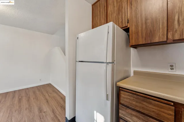 a white refrigerator freezer sitting inside of a kitchen