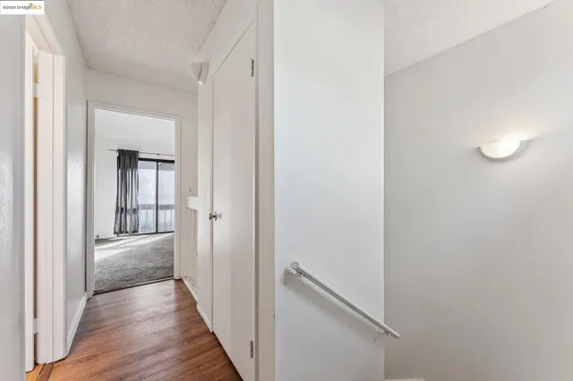 a view of hallway with wooden floor
